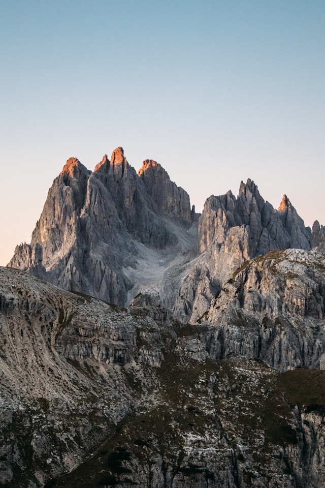 Rocky mountain peaks illuminated by golden sunset light